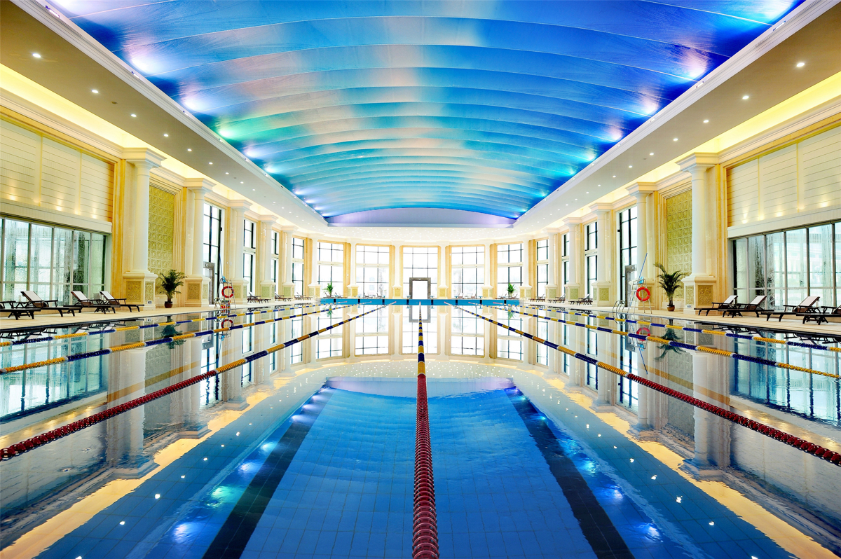 Child playing happily in pink tent inside hotel room