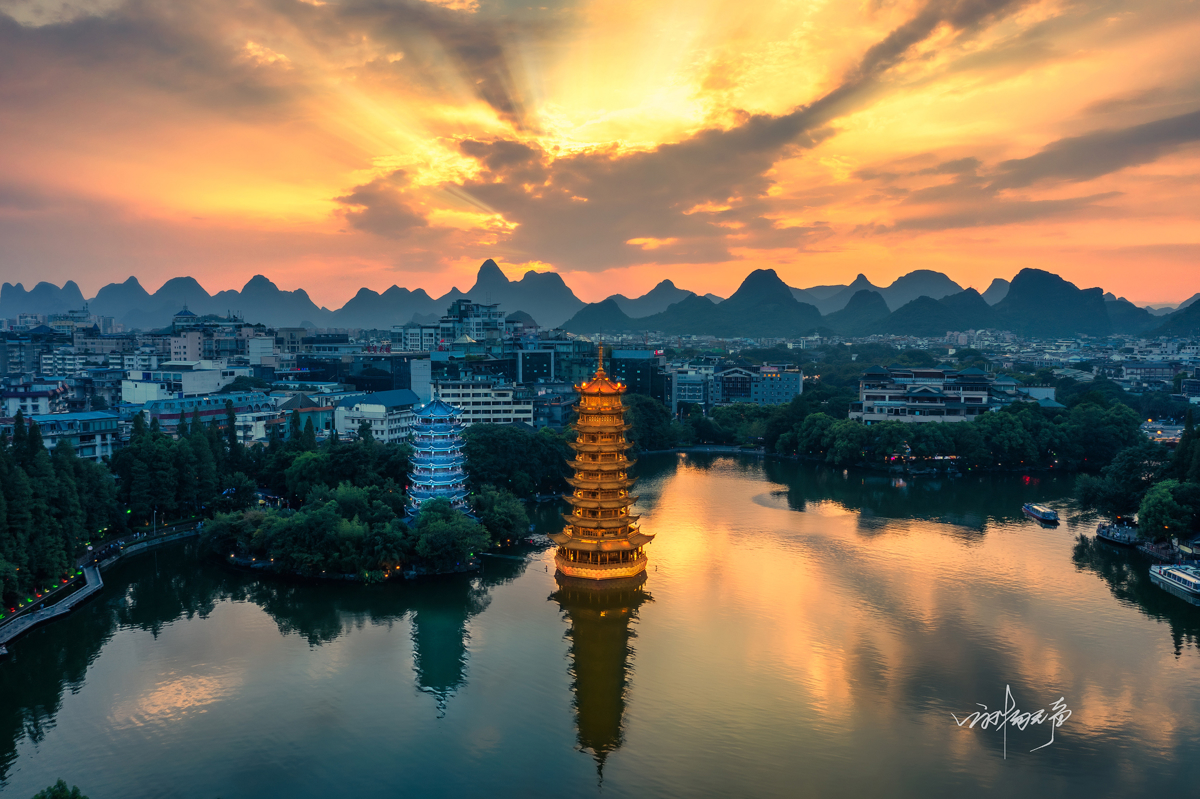 Sun and Moon Towers reflected in Shan Lake