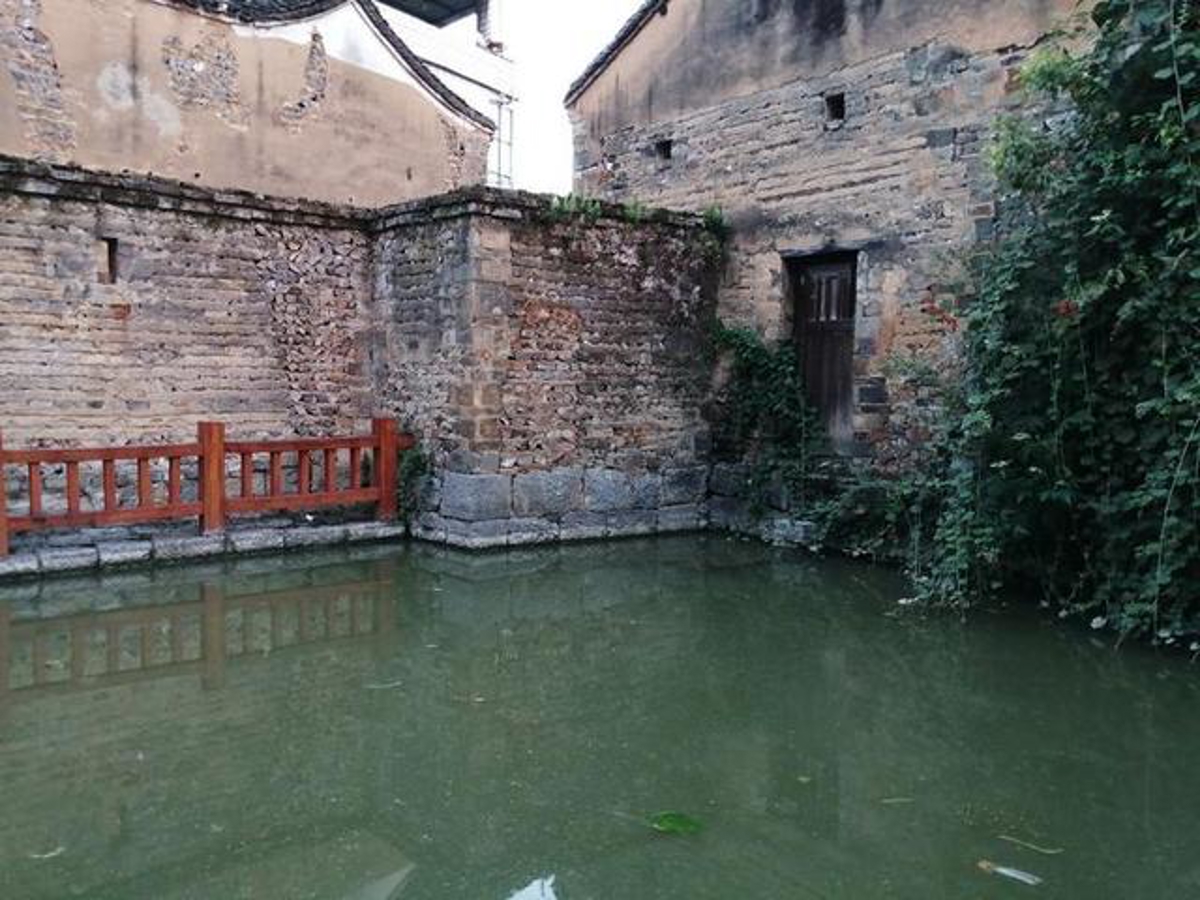 Old house beside the water pond