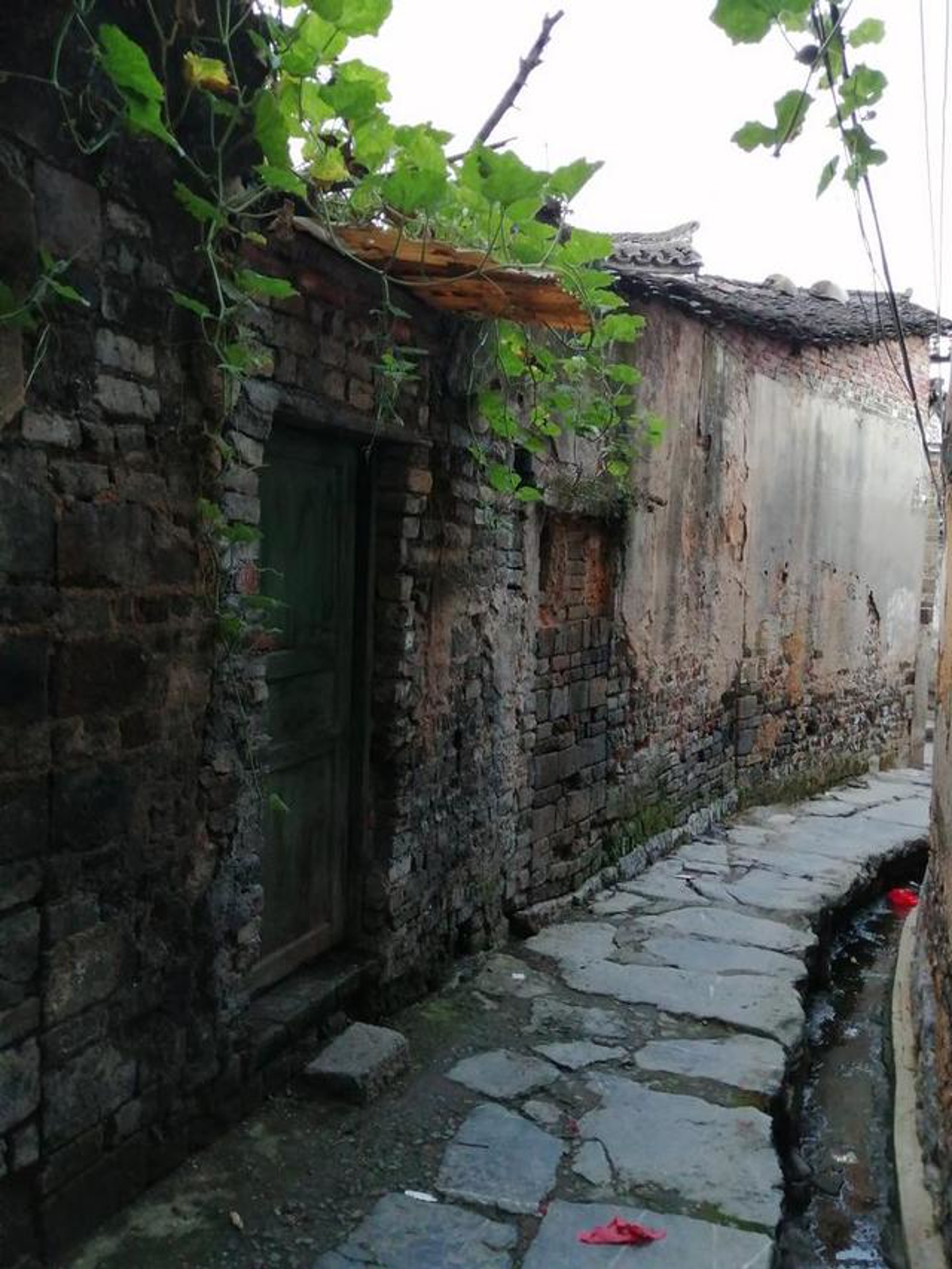 Stone drainage ditch alongside the path