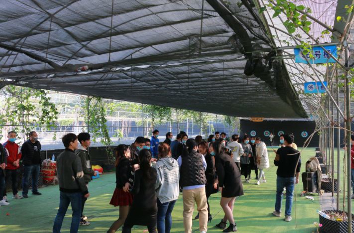 Outdoor cooking setup with traditional Chinese woks and wood-fired stoves